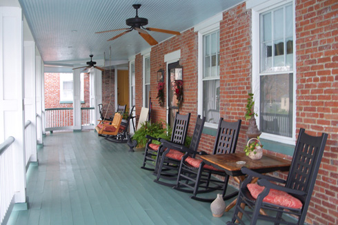 The upper veranda at Azalea Manor Bed and Breakfast in Indiana’s Madison Historic District along the Ohio River one mile north of Milton Kentucky